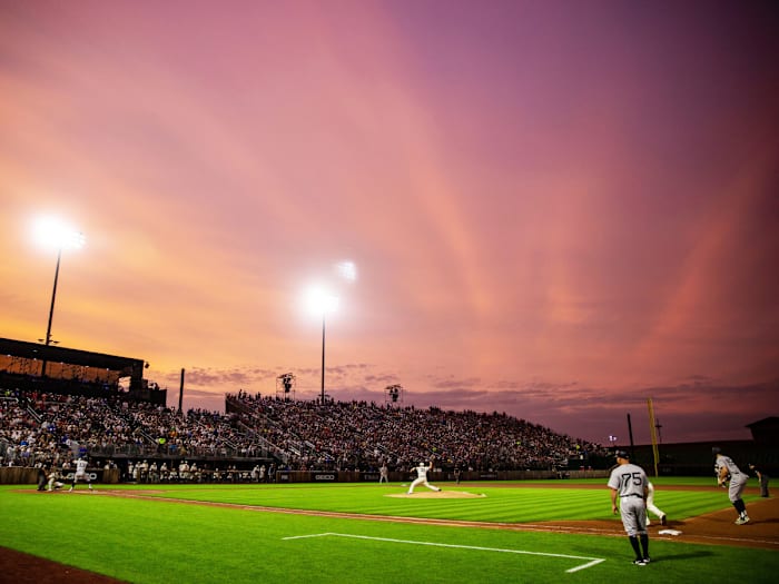 Orange hues paint the sky during the game between the New York Yankees and the Chicago White Sox near the Field of Dreams movie site outside of Dyersville, Thursday, Aug. 12, 2021.